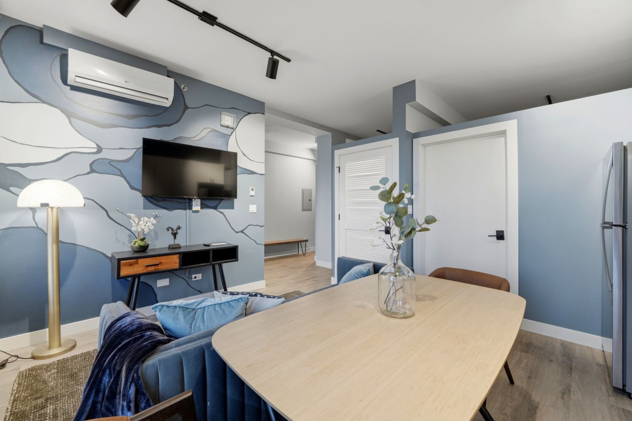 Blue abstract mural living room with kitchen and bedroom doors